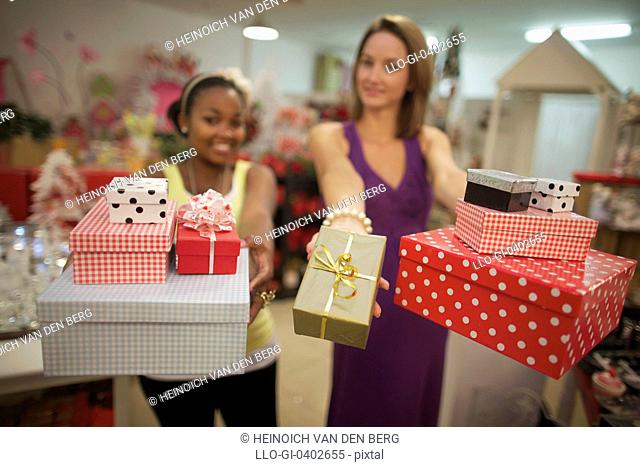 Two young women holding presents, Pietermaritzburg, KwaZulu-Natal, South Africa, friendship