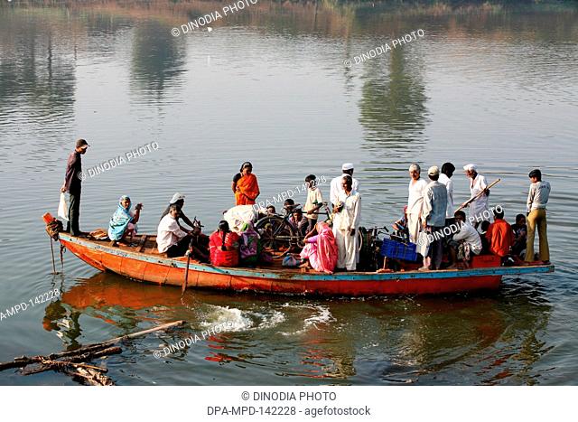 Villagers of the Haripur village loading their bicycles on a boat  ; Sangli district ; Maharashtra ; India