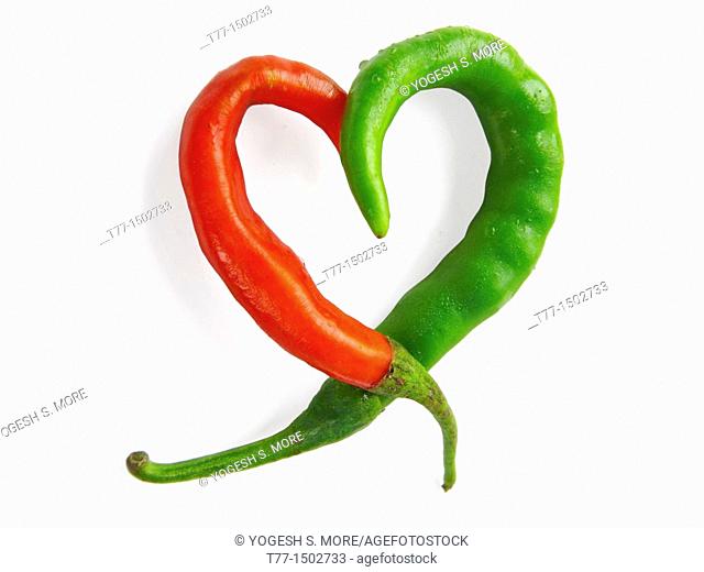 Common Chili  Capsicum annuum  Red and green chilies are kept in heart like shape  Pune, Maharashtra, India