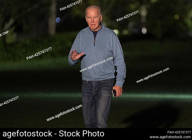 United States President Joe Biden waves to the media as he arrives on the South Lawn of the White House in Washington, DC following a weekend trip to India