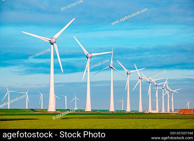 Windmills for electric power production Netherlands Flevoland, Wind turbines farm in sea, windmill farm producing green energy. Netherlands