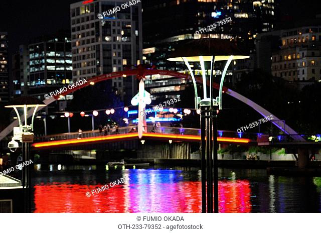 Evan Walker Bridge and the Ponyfish Island cafe underneath the bridge on Yarra River at night, Melbourne, Victoria, Australia