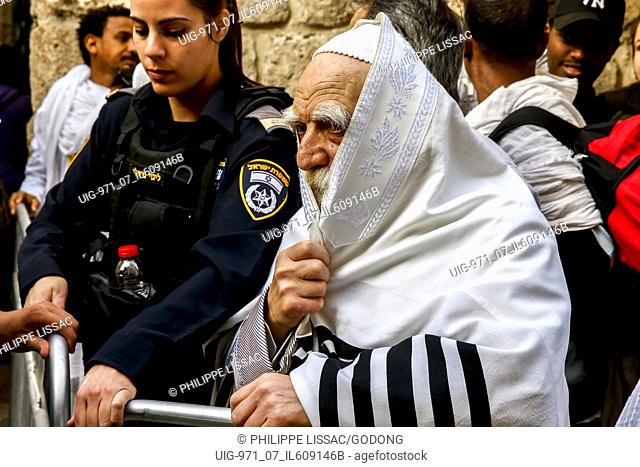 Jew wearing a taleth on his way to the western wall waiting at a control point in East Jerusalem during Easter week, Israel