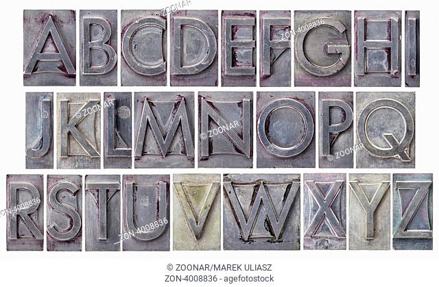 English alphabet - a collage of 26 isolated letters in grunge letterpress metal type, scratched and stained by ink