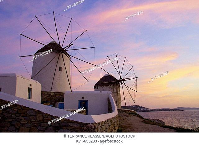 The windmills of Mykonos at dusk and sunset up on a hill at Hora or Mykonos town, Greece