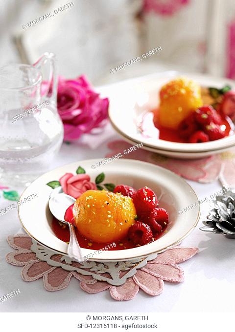 Poached peaches with rose water, pistachios and raspberries