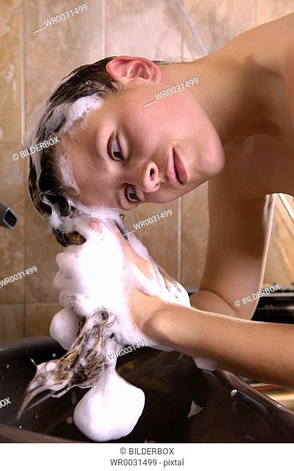 woman is washing her hair