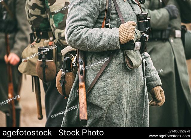 Close up of German military ammunition of a German soldier at World War II. Warm autumn clothes, soldier's overcoat, gloves, helmet, pouch, Sapper shovel, flask