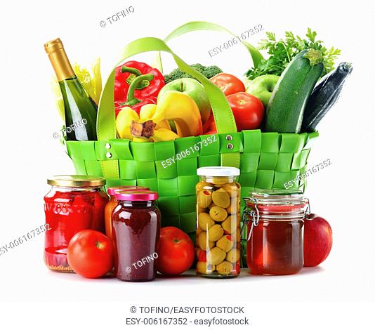 Green shopping bag with groceries isolated on white background