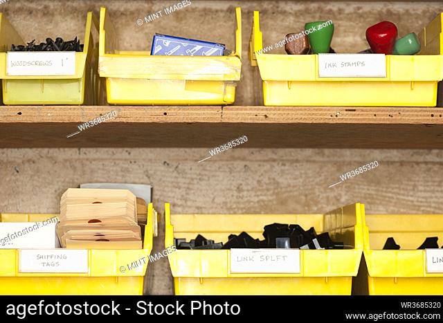 Containers with stationery on shelves