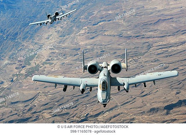 Two A-10 Thunderbolt IIs in-flight over Afghanistan supporting coalition forces  A-10s performs shows of force to deter enemy activities and provide armed...