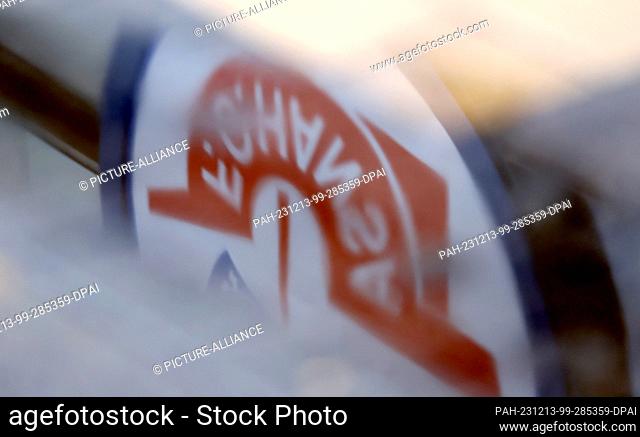 13 December 2023, Mecklenburg-Western Pomerania, Rostock: The logo of second division club FC Hansa Rostock is reflected in a puddle into which raindrops are...