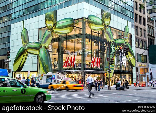 NEW YORK CITY - JULY 29, 2014: Modern HM shop in 5th street New York City with rushing cabs and people in front