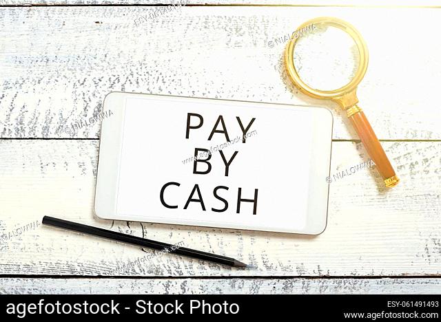 Handwriting text Pay By Cash, Concept meaning Customer paying with money coins bills Retail shopping Tablet Screen With New Ideas With Magnifier And Pencil...