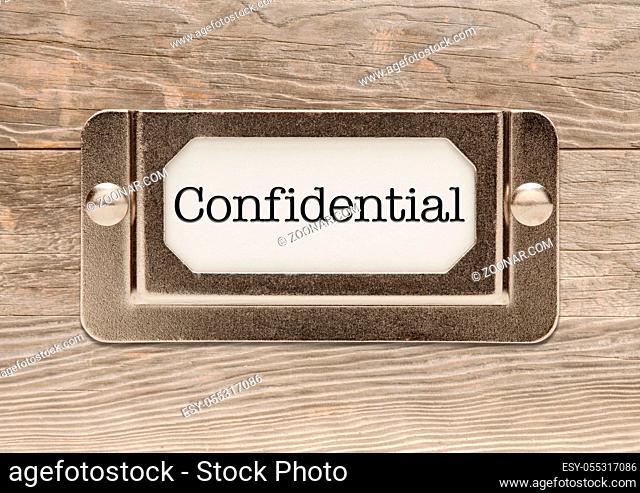Confidential Metal File Label Frame on Wood Background