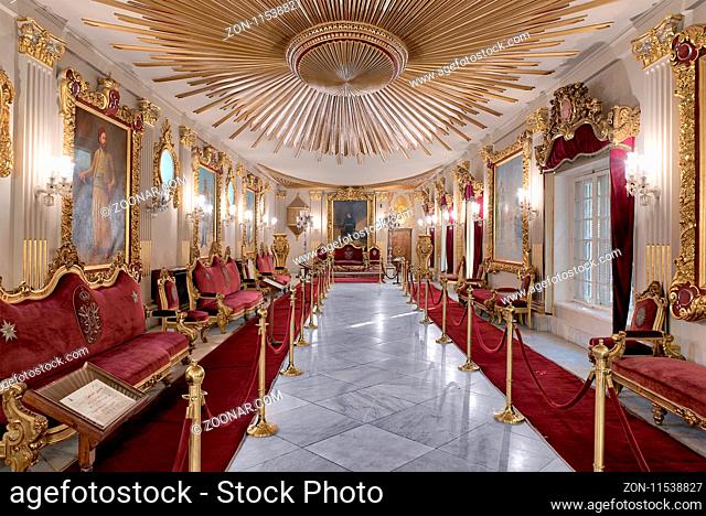 Throne Hall at Manial Palace of Prince Mohammed Ali Tewfik with ornate ceiling inspired by the old flag of the ottoman empire, gold plated armchairs