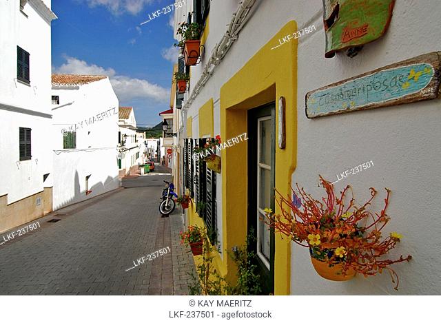 White painted houses and flower decorations in Ferreries, Minorca, Balearic Islands, Spain