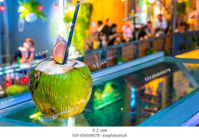 Fresh coconut drink served in the bar on the famous Train Street, popular tourist destination in old town Hanoi by night