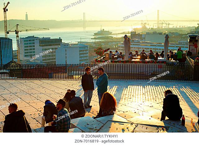 LISBON, PORTUGAL - DEC 22, 2014: Tourists having fun on the viewpoint of Lisbon. Tourism is contributing about 5% of the Gross Domestic Product