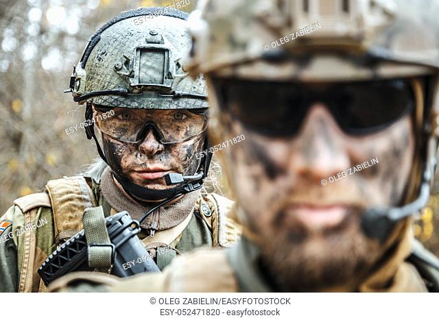 Norwegian Armed Forces Special Command FSK male and female soldiers closeup portrait. Radio and headset are on. Foreground defocus