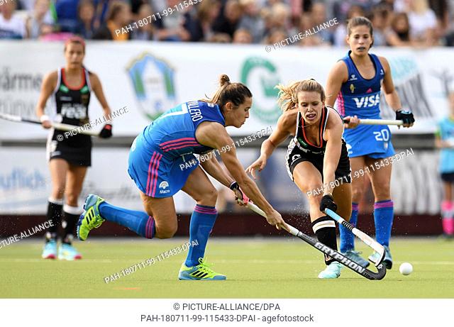 11 July 2018, Germany, Munich: Hockey, Womens: Four Nations Cup, Germany vs Argentina, 1st matchday: Anne Schroeder (R) of Germany and Martina Cavallero of...