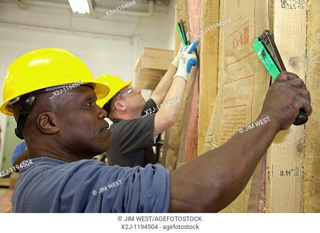 Detroit, Michigan - A class of disadvantaged people, including the unemployed, veterans, and high school dropouts, learns to install insulation as part of their...