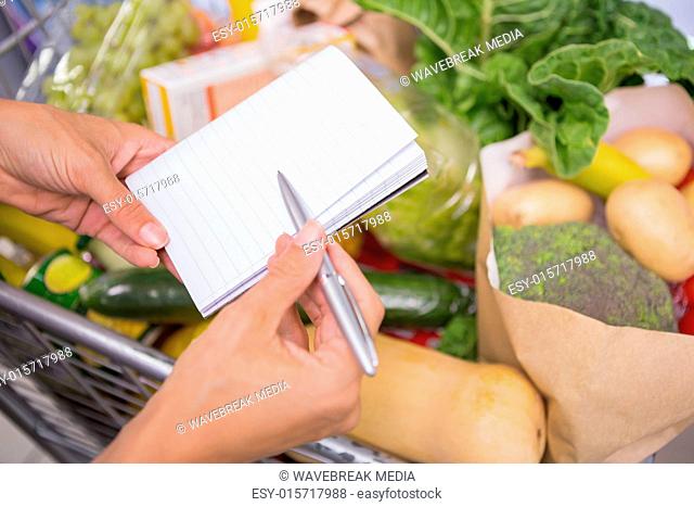 close up view of a notepad above a cart of product