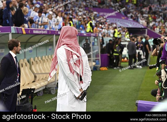 Qatar in traditional robe stands in front of the coach bench. Semi-final, semi-final game 61, Argentina (ARG) - Croatia (CRO) 3-0 on December 13th, 2022