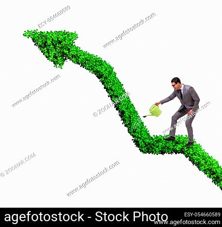 The businessman in investment concept watering financial line chart