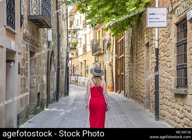 Tourist woman walking down street in Laguardia Rioja alavesa wine route. Alava. Basque country. Spain