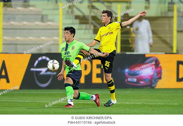 Dortmund's Pascal Stenzel vies for the ball with Jeonbuk's Lee Jongho (l) during the test match between Jeonbuk Hyundai Motors FC vs