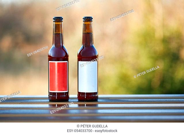 Tour beer bottles with blank labels on a table
