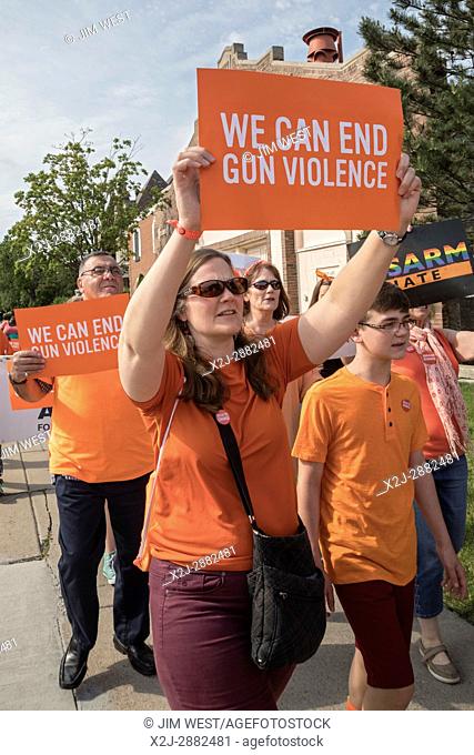 Detroit, Michigan USA - 3 June 2017 - Members of Moms Demand Action march to end gun violence. Participants chose orange as their color