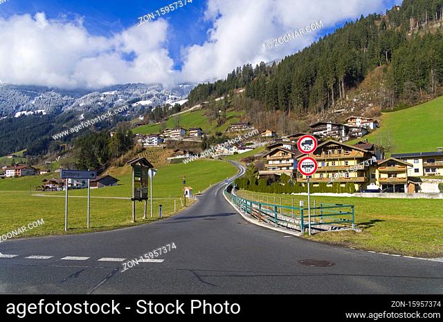Ziller Valley, Austria - March 8, 2020: The side road goes up into the mountains from the highway. Zillertal Valley, Tyrol, Austria, sunny day in early March