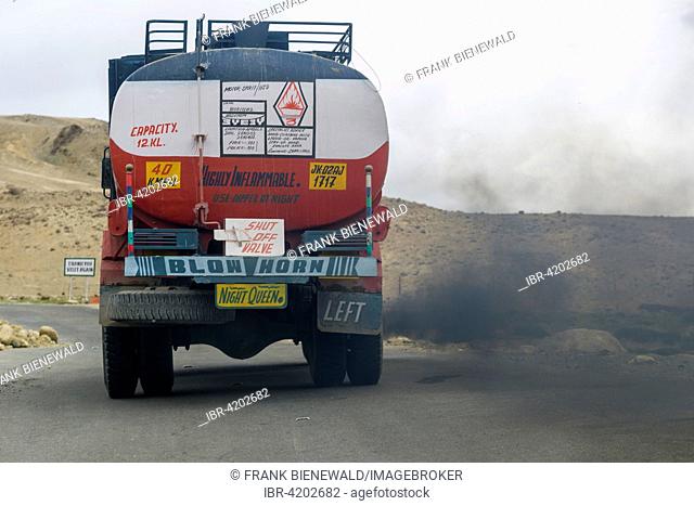 A truck, producing black fumes and pollution, is driving up to Taglang La, 5, 325 m, the highest pass on the Manali-Leh Highway, Rumtse, Jammu and Kashmir