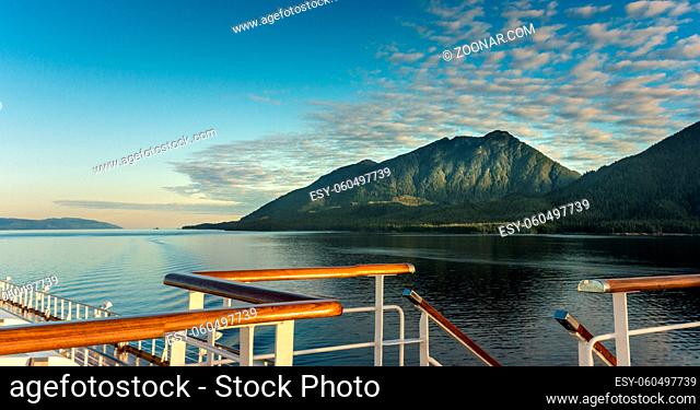 Railing and stairs, top deck of cruise ship, in golden early morning sunlight, Clarence Strait near Ketchikan, Alaska