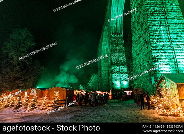 26 November 2021, Baden-Wuerttemberg, Breitnau: People stand between stalls at the Ravenna Gorge Christmas market, which takes place under an aqueduct