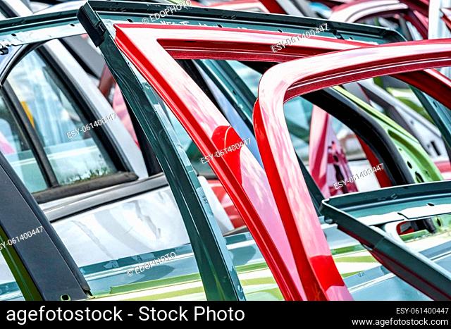 different colored car doors at a car junkyard