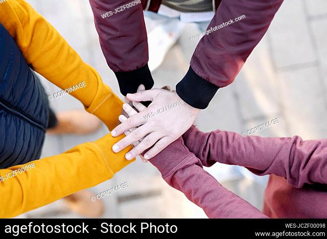 Close-up of friends stacking their hands