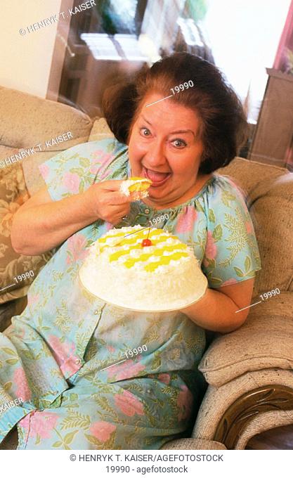 Fat woman eating cake