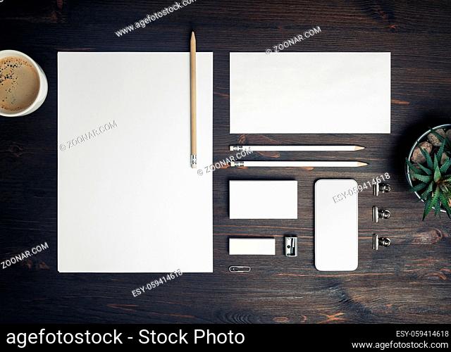 Blank branding identity set on wood table background. Corporate stationery template. Top view. Flat lay
