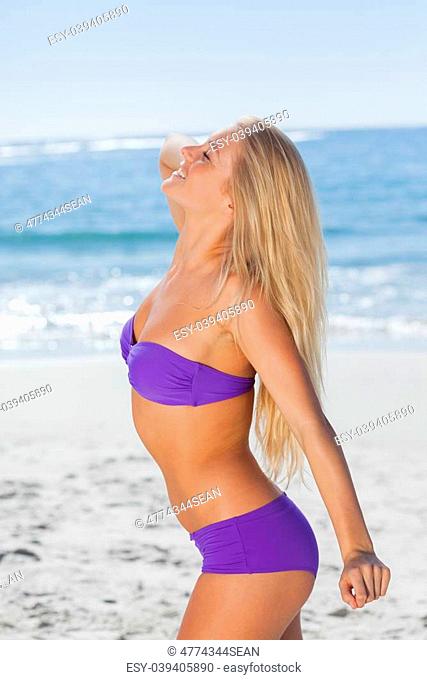 Attractive woman posing in front of camera on beach on holidays