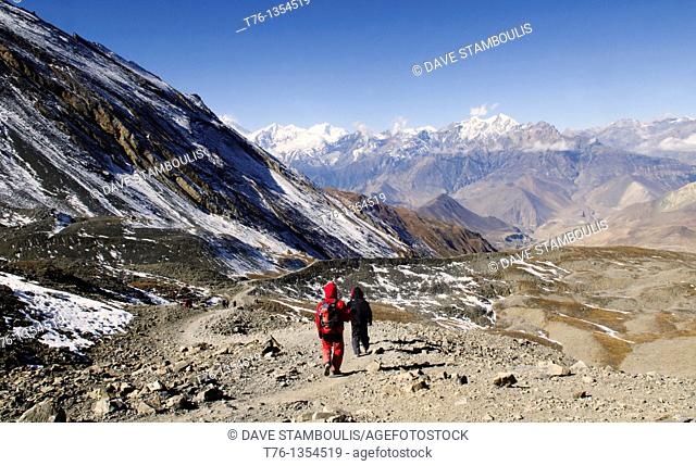 trekkers descending the Thorung La Pass 5416m in the Annapurna region of Nepal