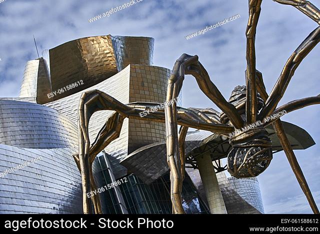 'Maman' sculpture by the French-American artist Louise Bourgeois 1911-2010 beside the Guggenheim Museum designed by architect Frank Gehry, Bilbao, Bizkaia