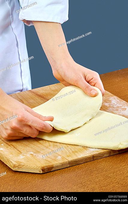 Woman rolls squeezes dough Handmade Series Food recipes Food being prepared and cooked in a contemporary kitchen, with and without the chef