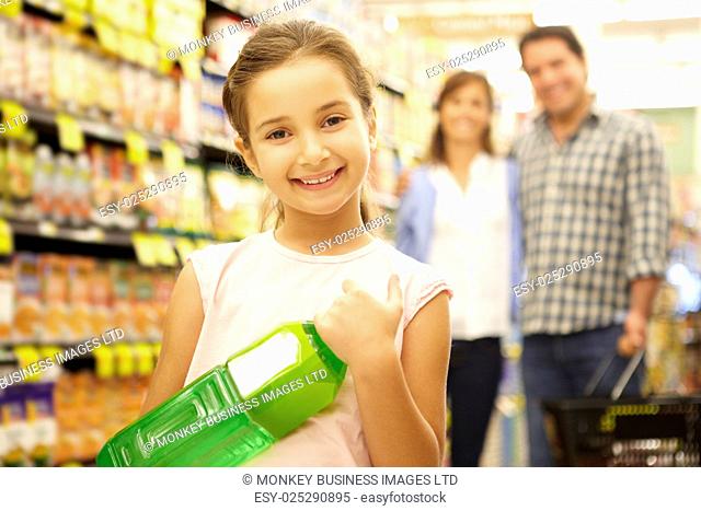 Girl helping parents with supermarket shopping