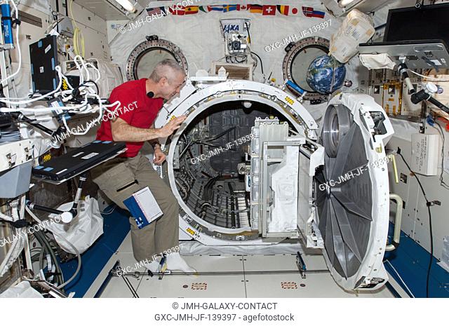 NASA astronaut Steve Swanson, Expedition 40 commander, works with equipment in the airlock in the Kibo laboratory of the International Space Station