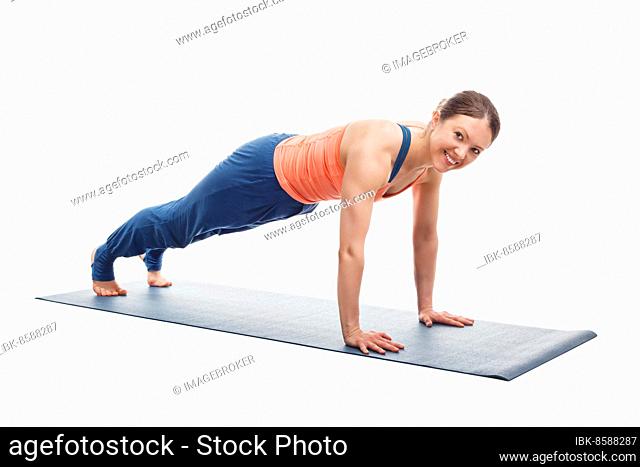 Smiling woman doing Ashtanga Vinyasa yoga asana Utthita chaturanga dandasana (or phalakasana), extended four-limbed posture plank pose isolated on white...