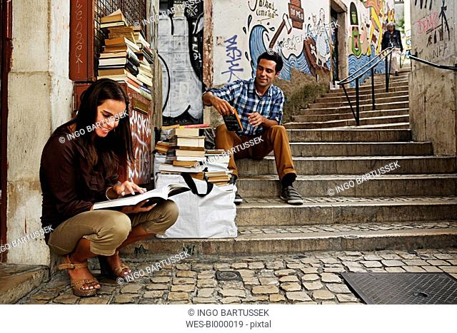 Portugal, Lisboa, Baixa, Rua do Madalena, young couple in front of antiquarian bookshop