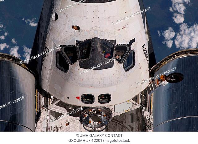 This partial view of the crew cabin and forward payload bay of the space shuttle Discovery was provided by an Expedition 23 crew member during a survey of the...